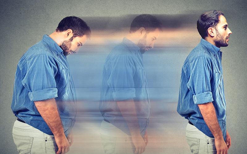 A man is shown on the left of the picture hunched forward, blurred toward his right-side image, as he completes healthy weight loss