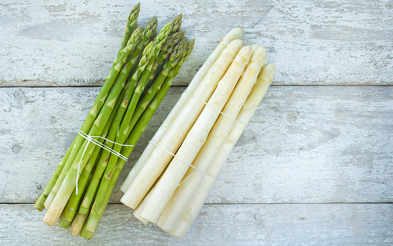 Bundle of asparagus lies on a table