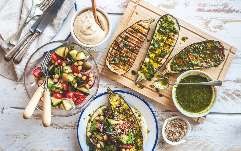 Ein gedeckter Tisch mit Salat, gesundem Brot und Aufstrich