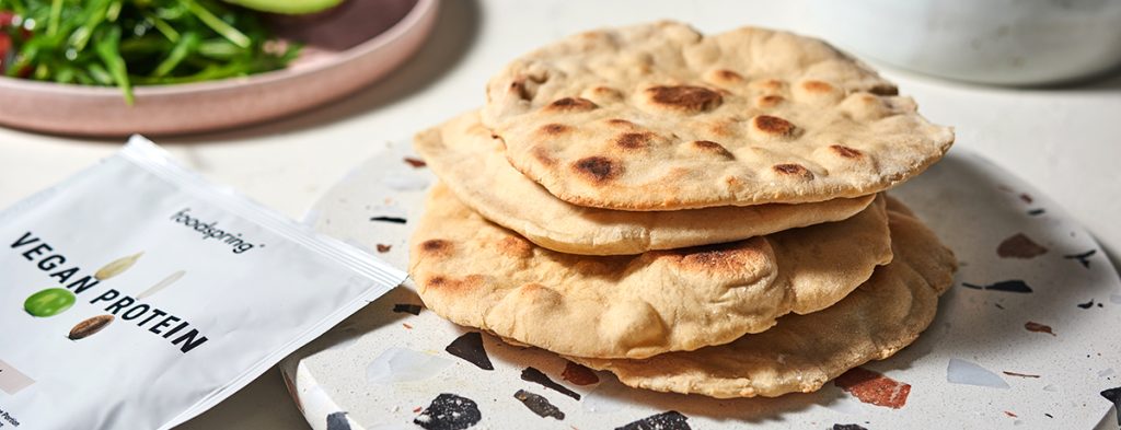 Four pockets of pita bread in a stack with lovely darkened brown spots