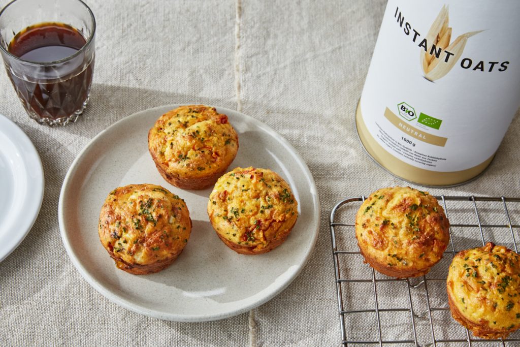 a plate and wire rack with savoury protein muffins and a cup of coffee