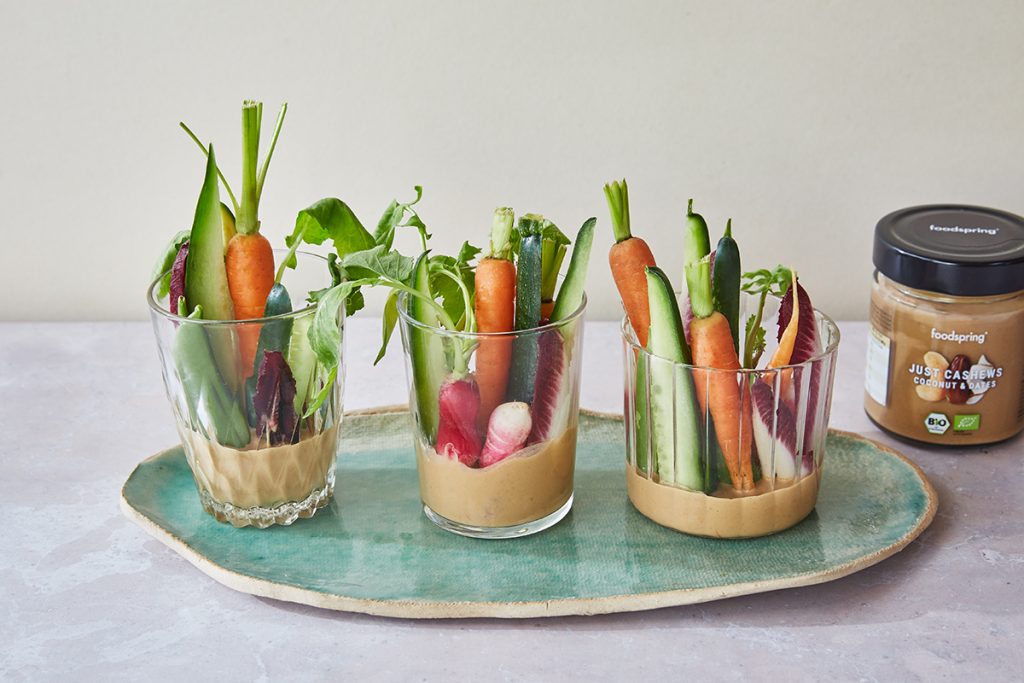 three glasses with nut butter & ginger dip and fresh vegetables