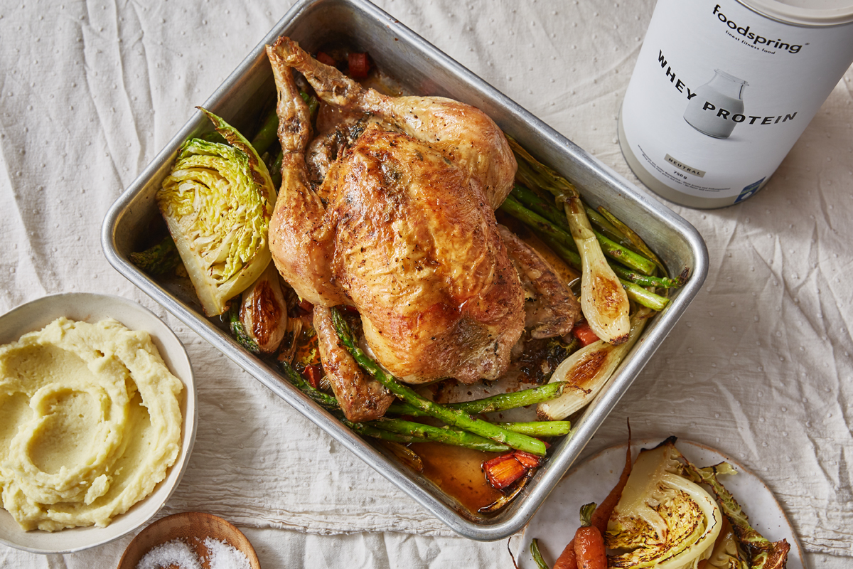 Roast Chicken with spring vegetables in a roasting dish with protein mashed potatoes